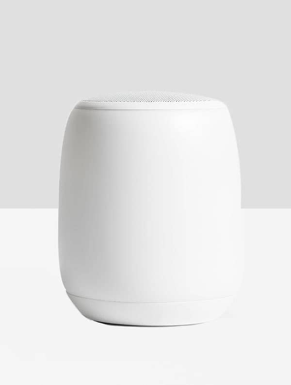 A minimalist wireless speaker on a desk